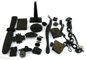 A mixed collection of jet and vulcanite including brooches, paper knife, watch chain, vesta etc