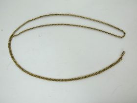 An antique yellow metal fancy link long spectacle chain with dog clip. Unmarked. Length: 130cm.