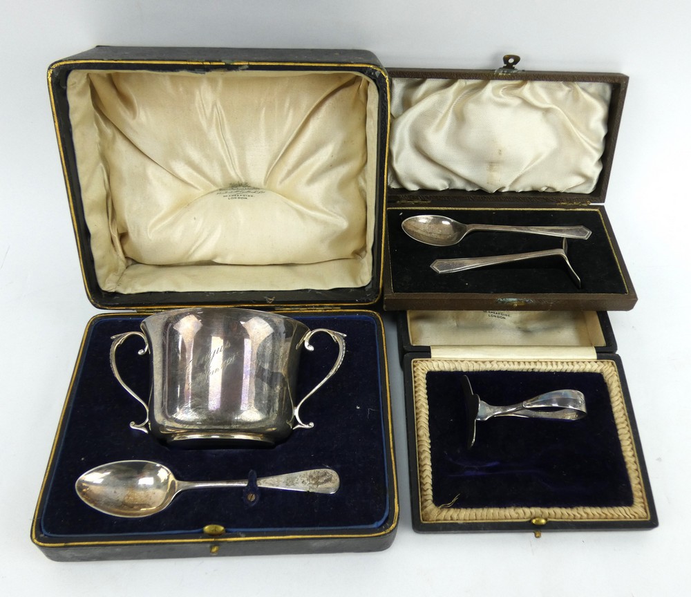 A boxed silver christening set, hallmarked 1918 and two other boxed silver christening sets.