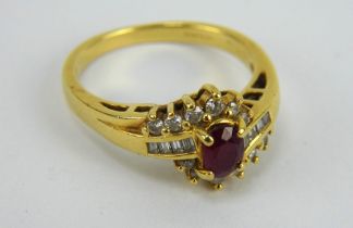 An 18ct gold ruby and diamond cluster ring