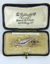 Diamond, emerald and ruby encrusted 18ct gold brooch of lizard form. Fully hallmarked.