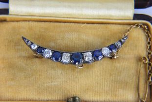 A sapphire and diamond crescent brooch