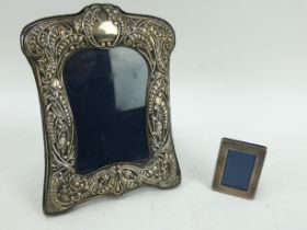 An antique style hallmarked silver fronted picture frame, 16cm x 21cm & a small silver fronted frame