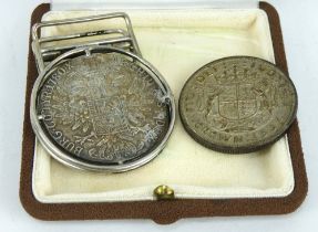 A 1780 Marie Therese thaler coin desk clip and a 1937 silver British crown coin.