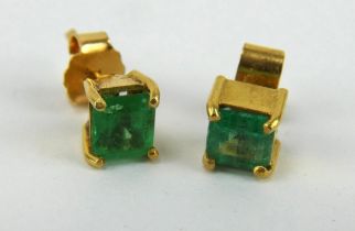 Pair of gold and emerald stud earrings. Backs marked 18K. Stones approx 5mm.