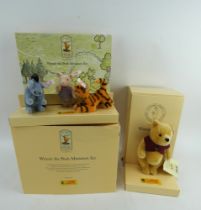 A Steiff 75th anniversary Winnie the Pooh and a Steiff Winnie the Pooh miniature set. Both boxed.