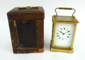 A brass cased French 8 day carriage clock in antique leather case. Key present. Height 14.5cm.