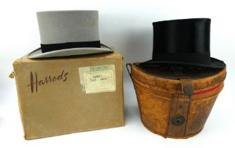 A black silk top hat in fitted leather box and a grey Harrods top hat in cardboard hat box.