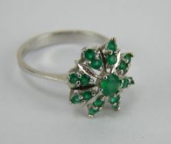 An emerald star cluster ring