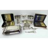 Mixed silver plated wares including wine coasters, cutlery, toast rack, serving dishes etc grape she