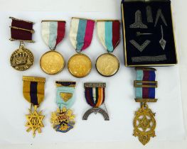 Eight mixed Masonic medals including four hallmarked silver, and a boxed set of Masonic symbols.