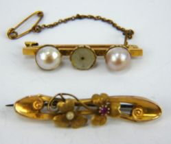 Two antique 15ct gold bar brooches, one set with pearls, the other with a floral design.