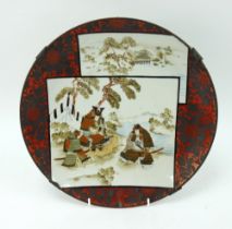 A n antique Japanese porcelain charger with samurai decoration on a red silvered ground. Signed.