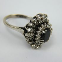 An 18ct white gold sapphire and diamond cluster ring