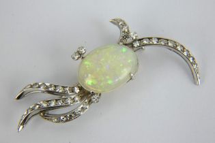 A stylish diamond and opal brooch