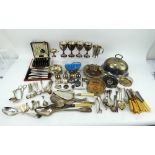 A mixed lot of silver plated table wares including cutlery, goblets, wine coasters, cruets, etc.