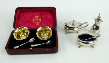 A Georgian style silver 3 piece condiment set and a boxed pair of silver salts with spoons.