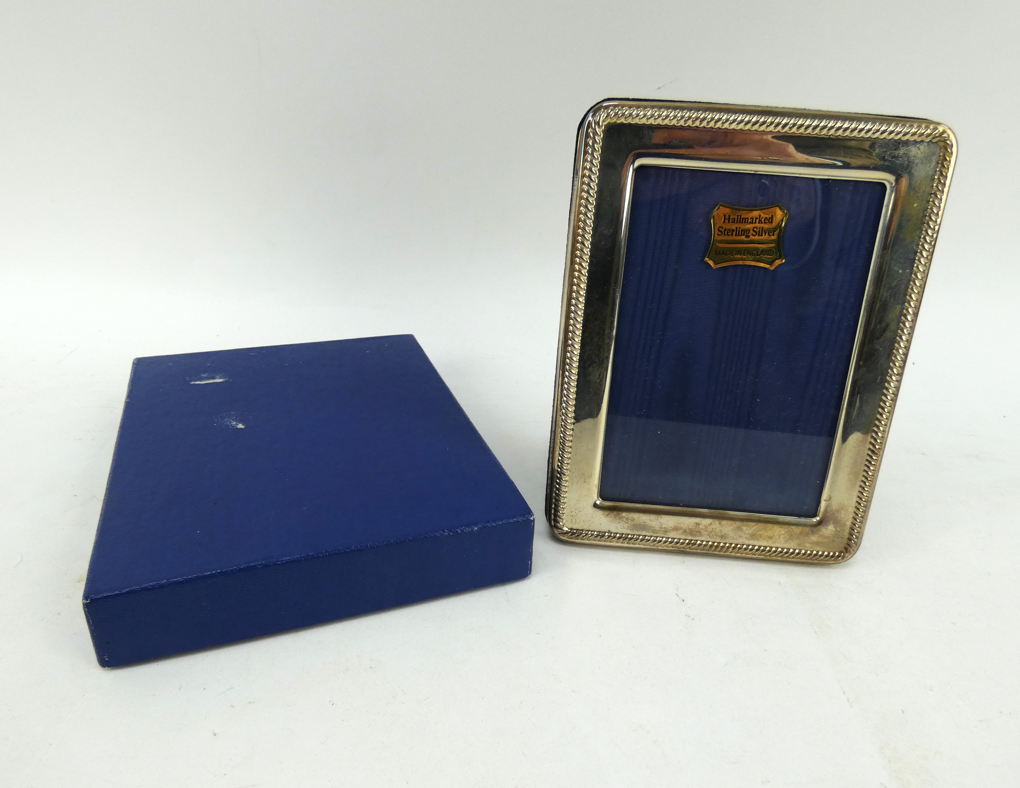 A hallmarked silver photo frame, 16cm x 12cm. Hallmarked for Birmingham 1994. Boxed.