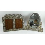 A large decorative Peruvian silver fronted double picture frame and a similar oval mirror frame