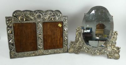 A large decorative Peruvian silver fronted double picture frame and a similar oval mirror frame