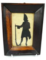 18th century cut card silhouette of a Grenadier soldier in uniform. Mounted in a period frame.