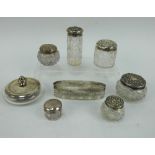 Eight antique hallmarked silver topped vanity glass jars of various size and style.