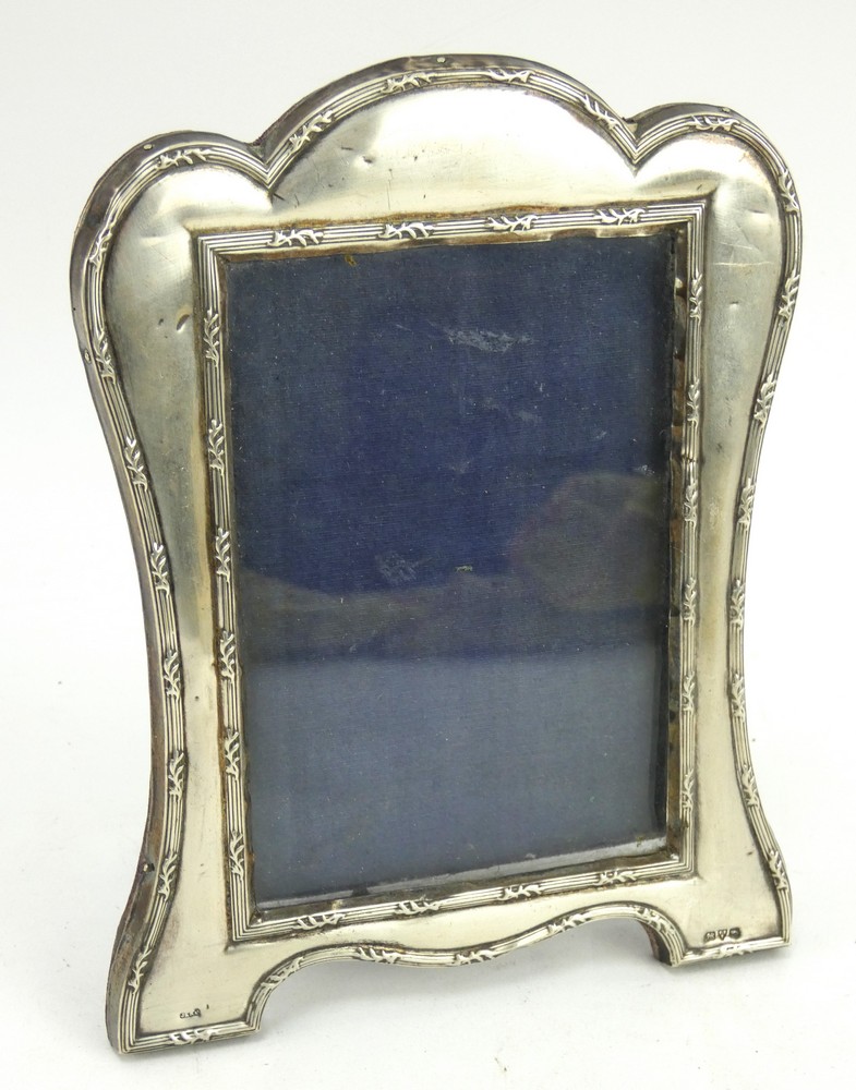 An Edwardian silver photo frame with velvet easel back, hallmarked Chester 1908, J & R Griffin.