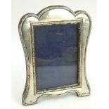 An Edwardian silver photo frame with velvet easel back, hallmarked Chester 1908, J & R Griffin.