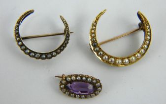 Two yellow metal and seed pearl crescent brooches and and amethyst and seed pearl brooch.