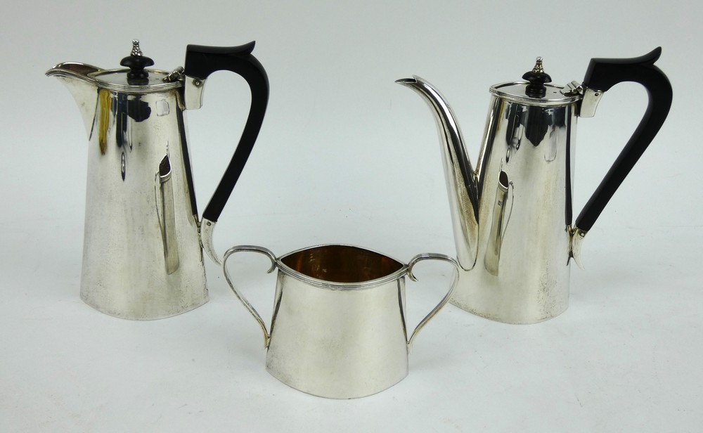 An Edwardian silver three piece cafe au lait set with ebony handles. Hallmarked Sheffield 1908
