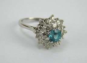 An 18ct white gold blue topaz and diamond cluster ring