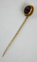 An18ct gold stick pin with inset facet cut amethyst. Fully hallmarked London 1896. Length 6.4cm.