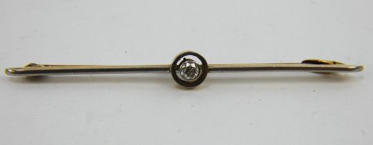 A yellow metal Art Deco bar brooch with single diamond. Indistinct marks. Length 6.4cm.