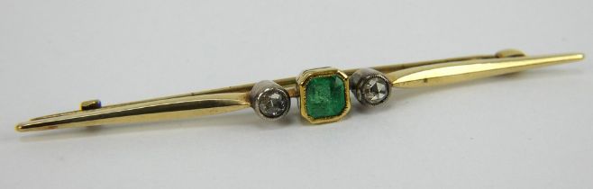 A diamond and emerald bar brooch