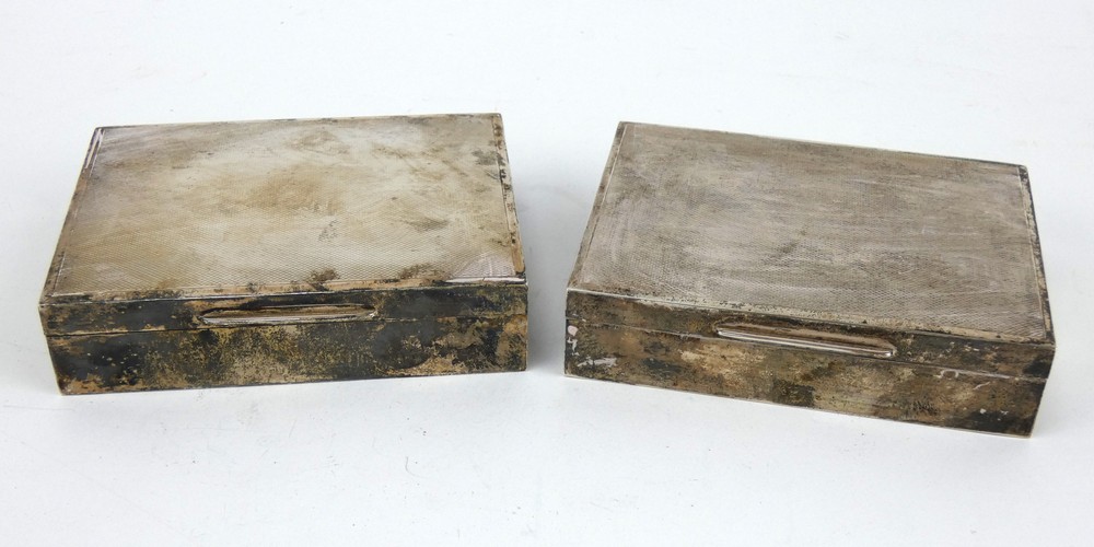 Matching pair of engine turned silver cigarette boxes. Hallmarked Walker & Hall, Chester 1938