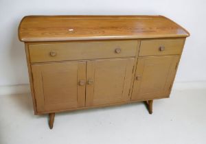 Mid 20th century Ercol sideboard with two drawers above three cupboard doors.