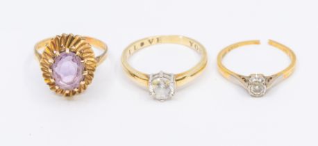 A collection of three stone set gold rings, to include a cubic zirconia 9ct gold solitaire, size