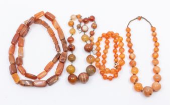 A collection of four banded agate and carnelian bead necklaces including round and elongated