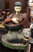 A large mid-20th century wooden figure of a seated Thai woman playing a musical instrument, 75cm