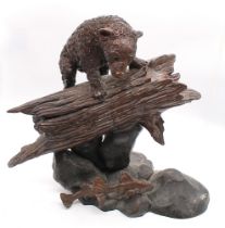 20th century bronze figure of a brown bear on a log, looking down at two fish, unsigned 37cm high