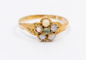 A Victorian emerald and opal 15ct gold ring, comprising a flower motif set to the centre with a