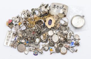 A collection of silver and white metal, plated metal charms, rings, brooches, chains, pendants,