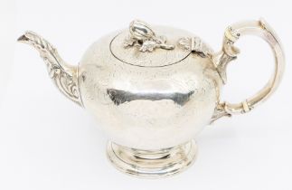 A Victorian silver teapot, globular with engraved decoration, acanthus leaf spout and nut finial,