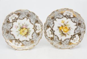 Coalport - Two hand painted floral decorated plates, fluted edged, one faintly signed by F.