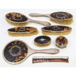 A matching George V silver and faux tortoiseshell dressing table set consisting of hand mirror,