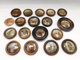 A collection of late 19th century Pratt ware lids with mixed transfer designs in oak frames