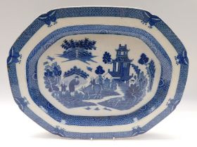 An English 19th century blue and white meat platter printed with boy on a buffalo pattern, size 57cm