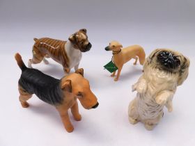 Four boxed Beswick dogs, whippet, boxer, pekingese and airedale.