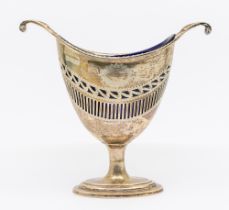 A George V pierced silver sugar basket, of helmet form with scrolled handles, oval footed base and