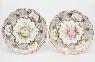 Coalport - Two hand painted floral decorated plates, fluted edged, signed by F. Howard. (2)